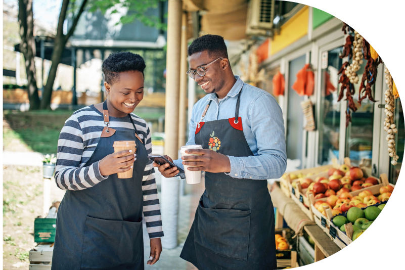 People having coffee and looking at a phone.